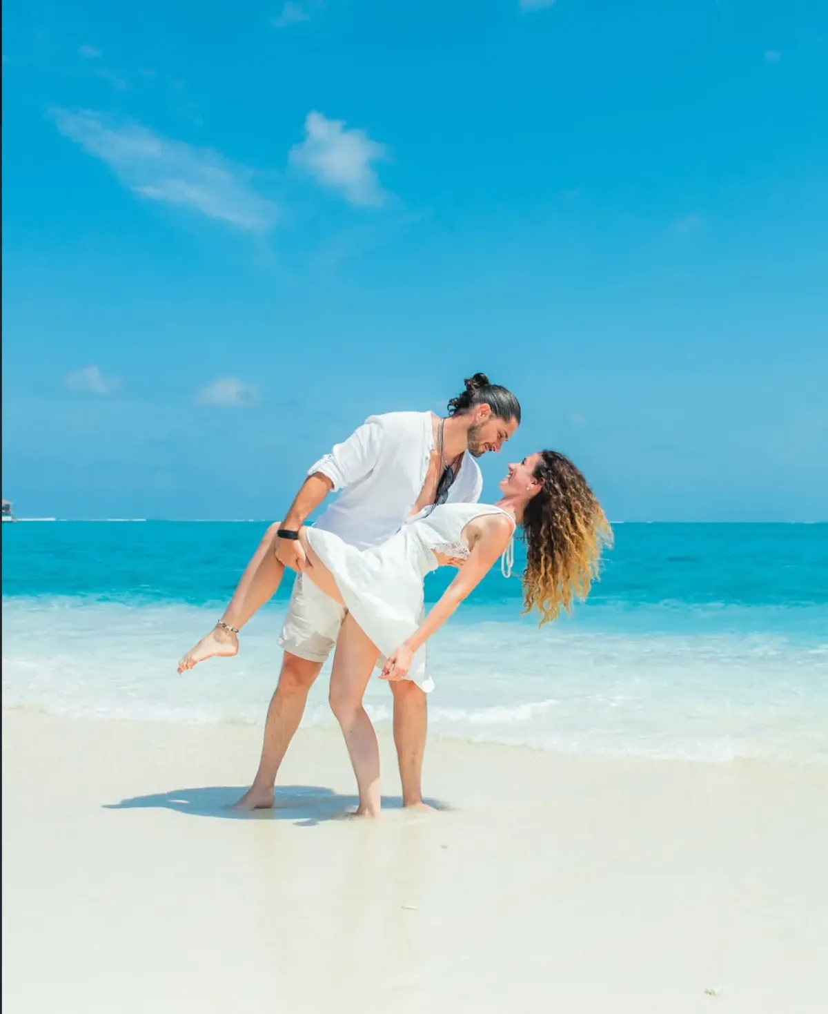 Honeymoon couple on a Maldives beach at sunset