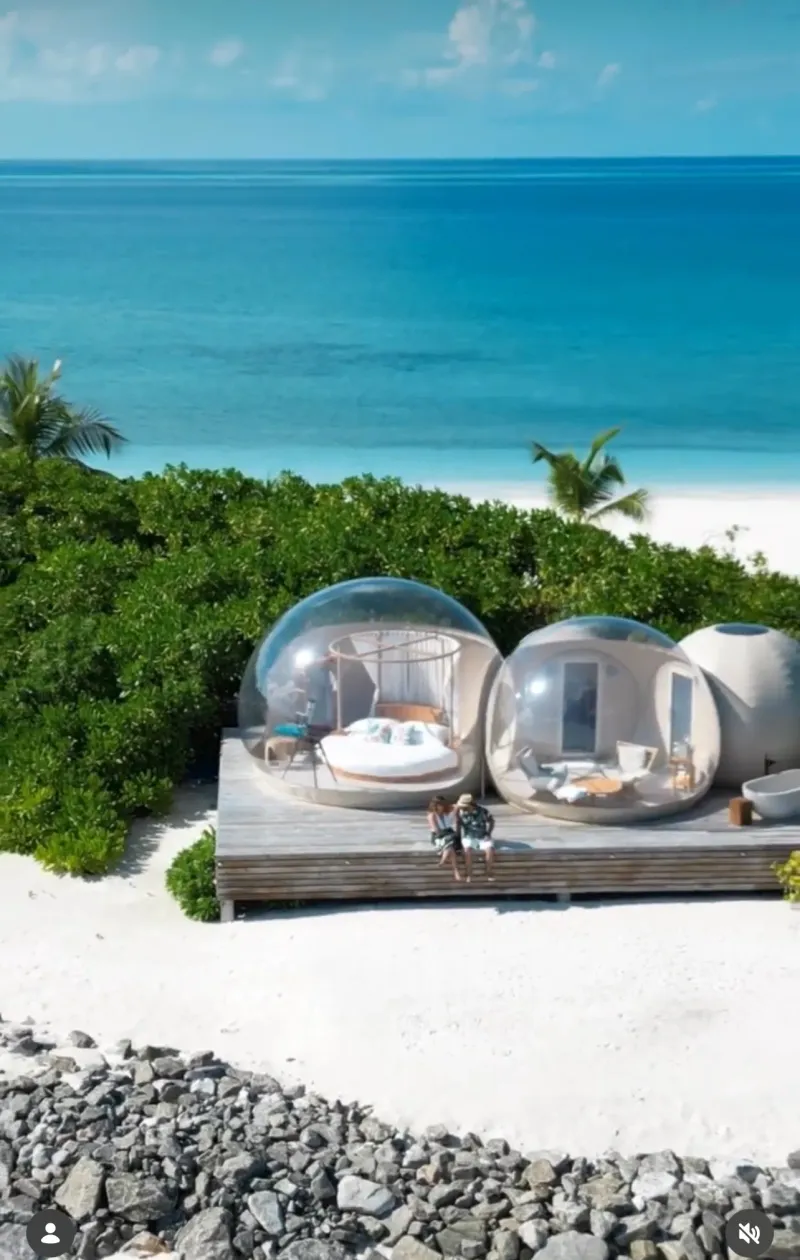 Couple at a romantic dinner setup on a Maldives beach