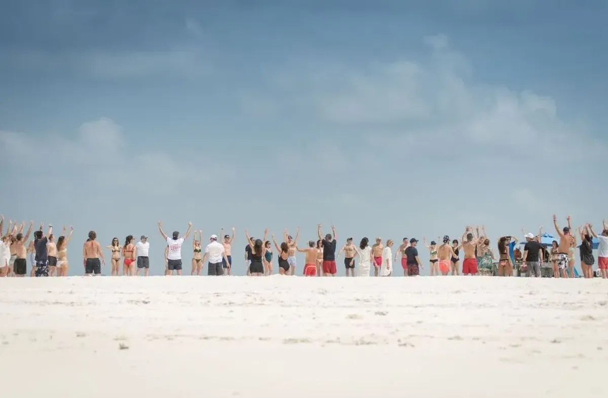 Guests celebrating together on a Maldives sandbank
