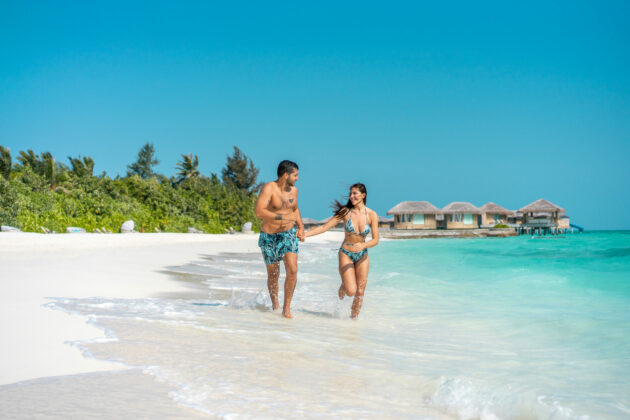 Couple running along the shore